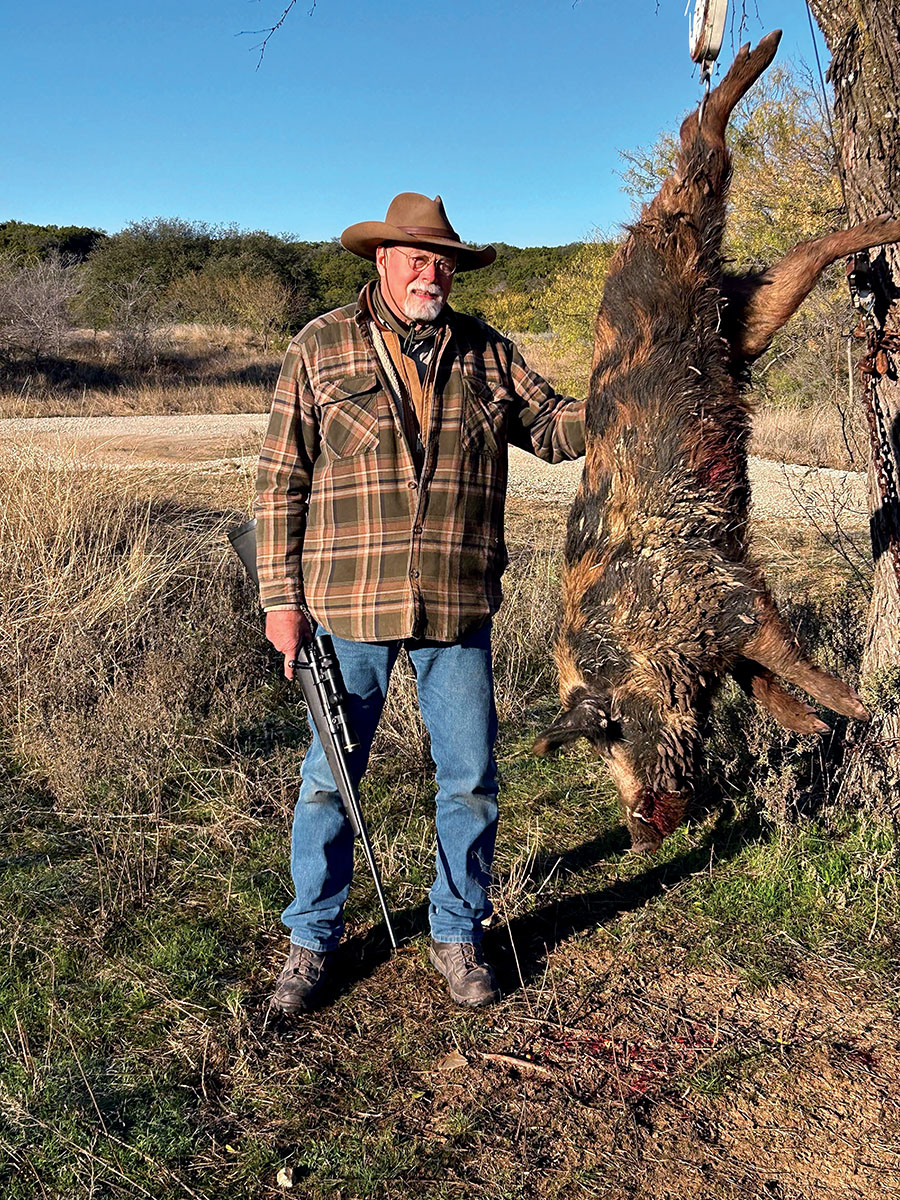Ashley Emerson, quintessential conservative hog hunter with the day’s prize ready for skinning. That mud on the pig becomes an additional layer of body armor when it dries.